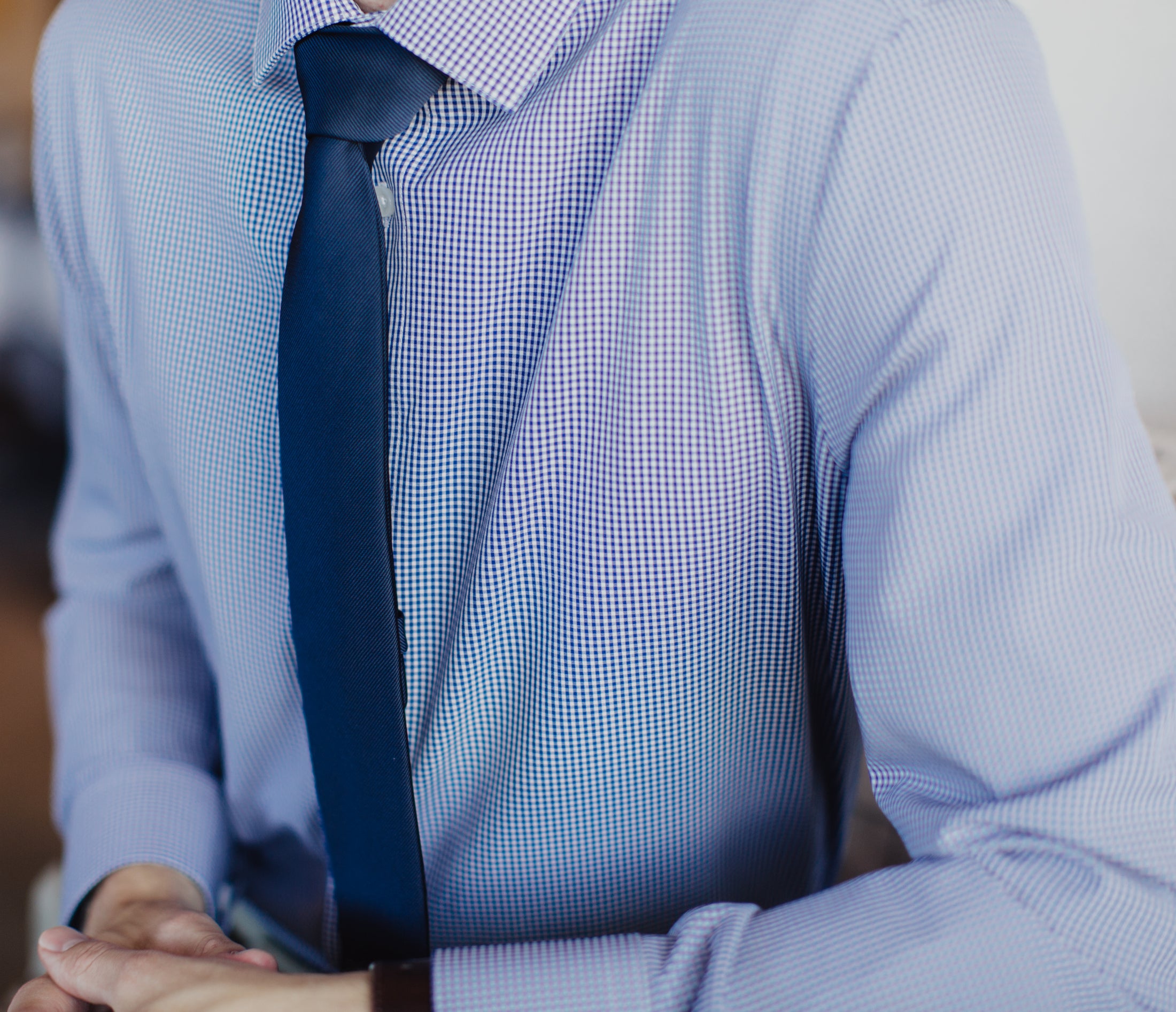 Close up of man wearing mens navy plaid dress shirt with with navy tie